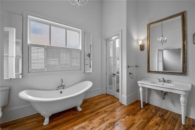 6978 Canal Blvd, New Orleans, LA 70124 - full bathroom with a freestanding bath, a chandelier, and wood finished floors