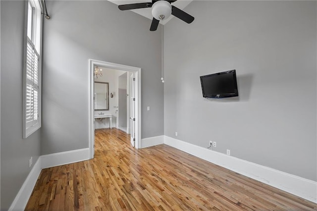 6978 Canal Blvd, New Orleans, LA 70124 - unfurnished bedroom with light wood finished floors, multiple windows, and a ceiling fan