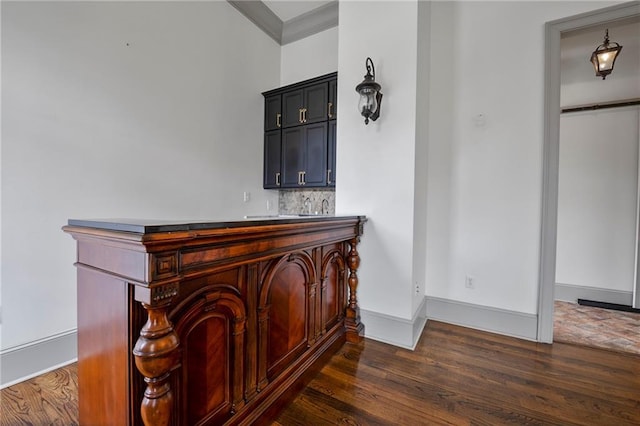 6978 Canal Blvd, New Orleans, LA 70124 - indoor bar featuring dark wood-type flooring, crown molding, and tasteful backsplash
