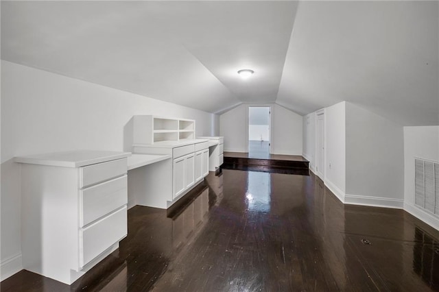 6978 Canal Blvd, New Orleans, LA 70124 - additional living space with dark wood finished floors, lofted ceiling, and built in shelves