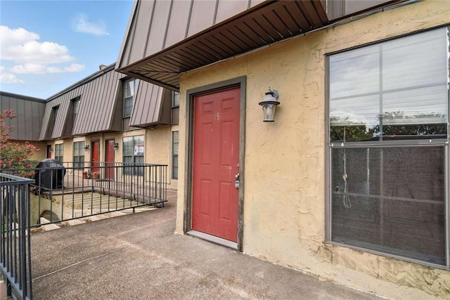 10286 W Winston Ave Unit 15, Baton Rouge, LA 70809 - view of exterior entry featuring stucco siding and board and batten siding