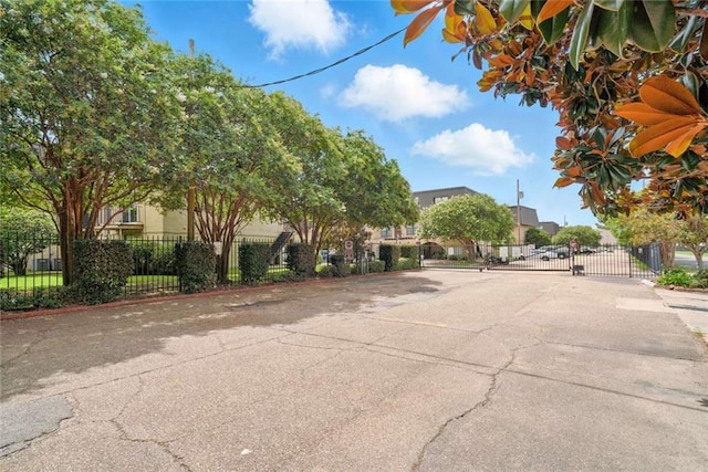 10286 W Winston Ave Unit 15, Baton Rouge, LA 70809 - view of asphalt street with a gated entry, a residential view, and a gate