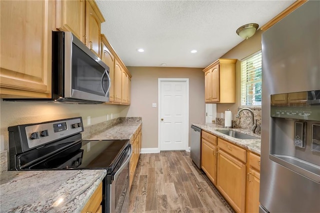 3542 Peachtree St, Slidell, LA 70458 - kitchen with stainless steel appliances, light wood-type flooring, light stone countertops, a textured ceiling, and recessed lighting