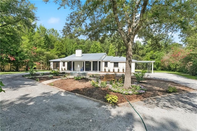 72287 Military Rd, Covington, LA 70435 - single story home with a porch, driveway, and a chimney