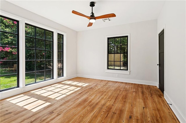 72287 Military Rd, Covington, LA 70435 - empty room featuring plenty of natural light, hardwood / wood-style floors, and ceiling fan