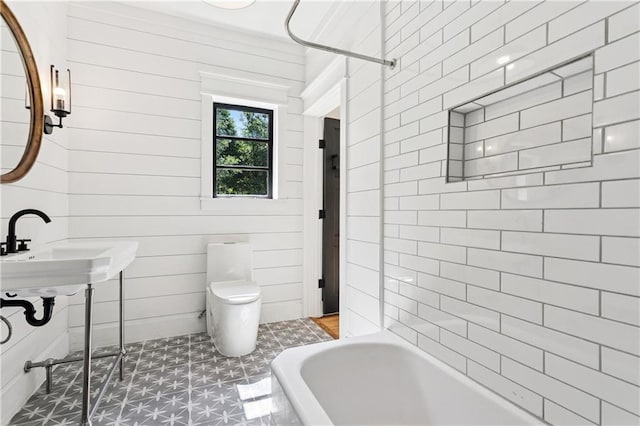 72287 Military Rd, Covington, LA 70435 - bathroom featuring tile patterned floors and wooden walls