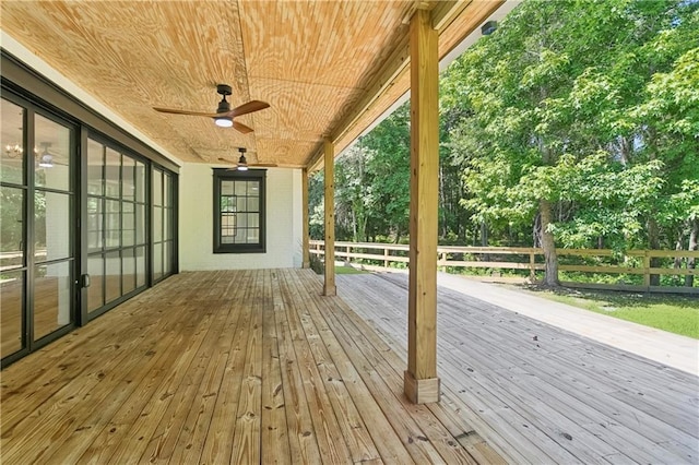 72287 Military Rd, Covington, LA 70435 - wooden terrace featuring a ceiling fan and view of wooded area