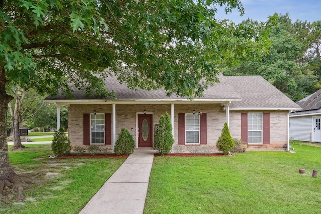 70105 10th St, Covington, LA 70433 - view of front of house featuring a front lawn, brick siding, and a shingled roof