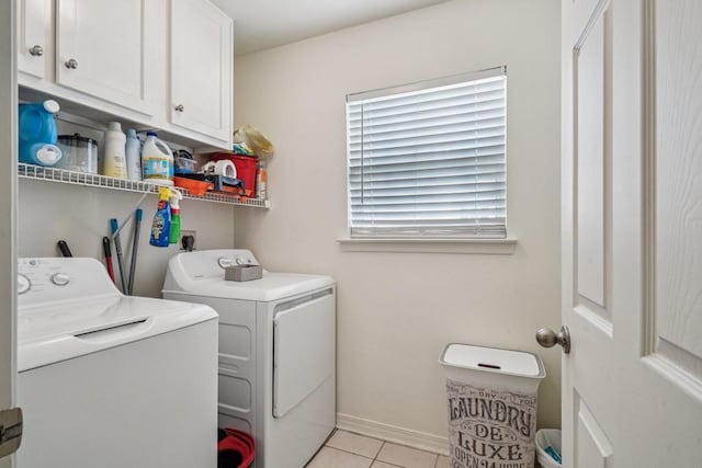 70105 10th St, Covington, LA 70433 - washroom featuring separate washer and dryer, light tile patterned floors, and cabinet space