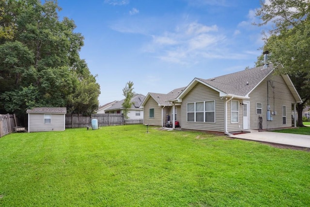 70105 10th St, Covington, LA 70433 - back of property with a fenced backyard, a storage unit, and a shingled roof