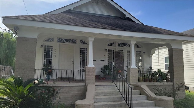 177375 N Dorgenois St, New Orleans, LA 70119 - entrance to property featuring covered porch, a shingled roof, and brick siding