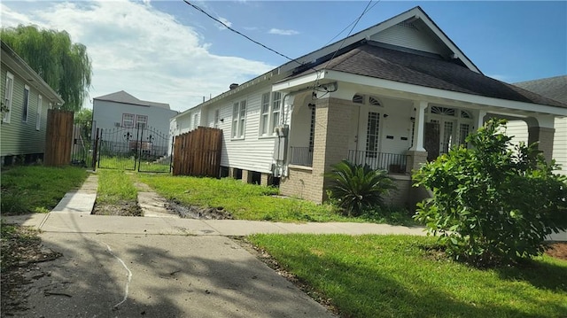 177375 N Dorgenois St, New Orleans, LA 70119 - view of home's exterior with brick siding, a porch, and a shingled roof