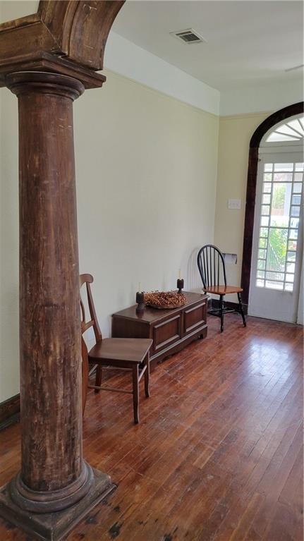 177375 N Dorgenois St, New Orleans, LA 70119 - living area with ornate columns, arched walkways, and dark wood-style flooring