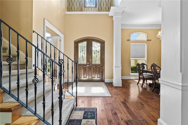 412 Aspen Ln, Covington, LA 70433 - entrance foyer with a high ceiling, wood finished floors, decorative columns, stairway, and ornamental molding