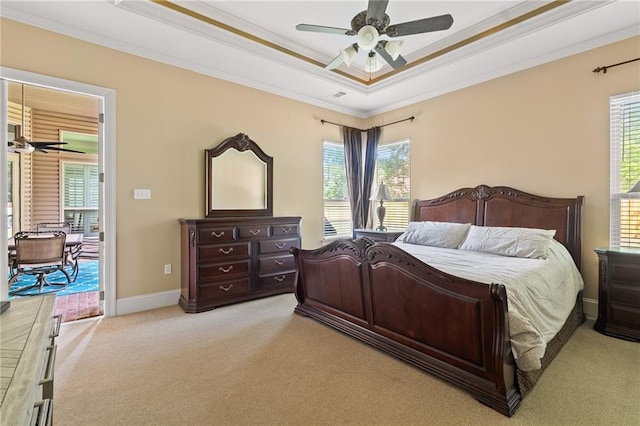 412 Aspen Ln, Covington, LA 70433 - bedroom with light colored carpet, a tray ceiling, ornamental molding, and multiple windows