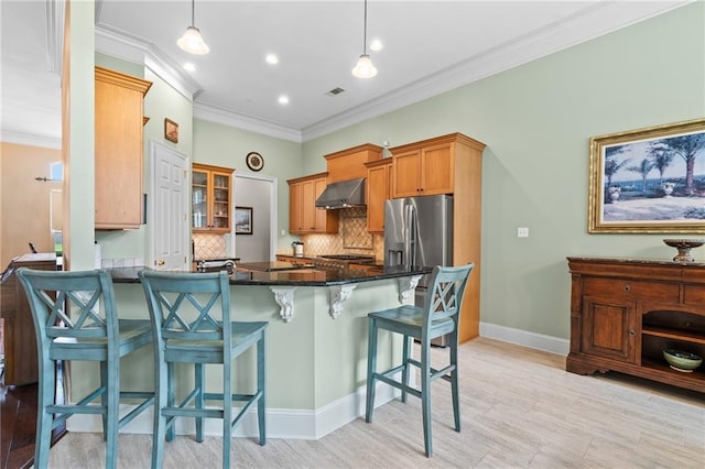 412 Aspen Ln, Covington, LA 70433 - kitchen with wall chimney exhaust hood, a peninsula, backsplash, a kitchen bar, and ornamental molding