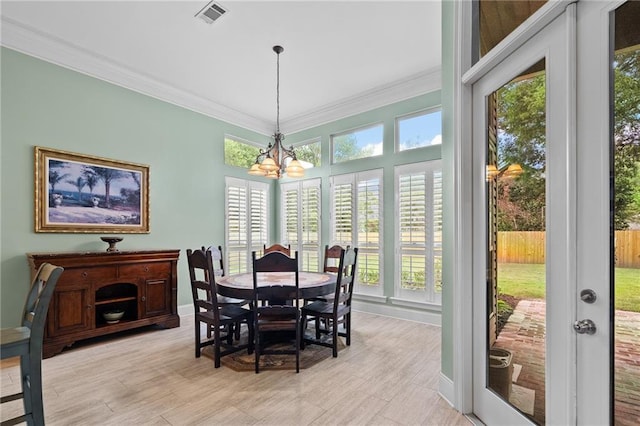 412 Aspen Ln, Covington, LA 70433 - dining area featuring a chandelier, ornamental molding, and light wood-style flooring