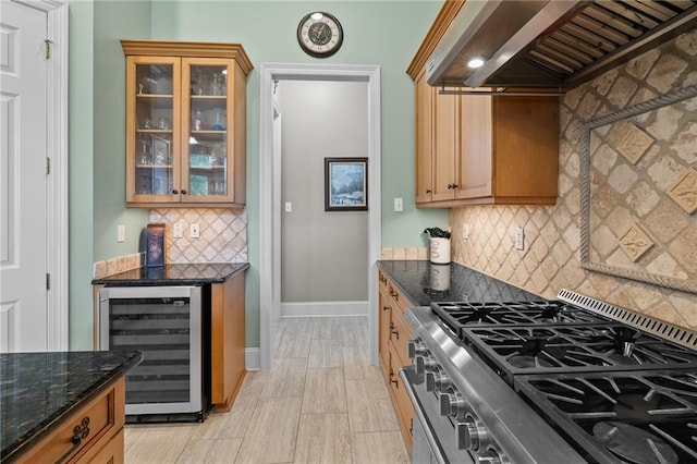 412 Aspen Ln, Covington, LA 70433 - kitchen with wine cooler, stainless steel gas stove, ventilation hood, backsplash, and dark stone countertops