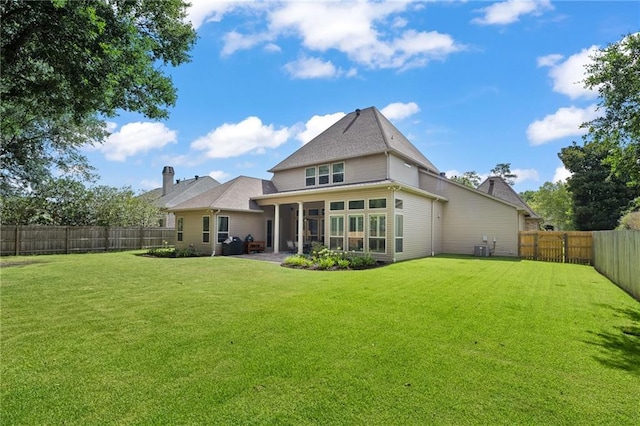 412 Aspen Ln, Covington, LA 70433 - back of house with a fenced backyard and a sunroom