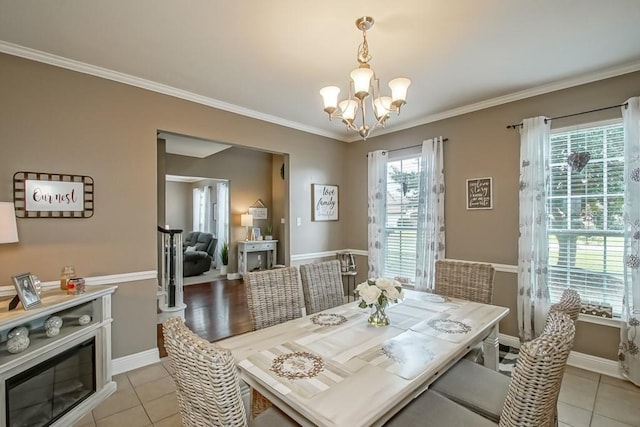 784 Lakeview Ln, Covington, LA 70435 - dining area with a chandelier, light tile patterned floors, and ornamental molding