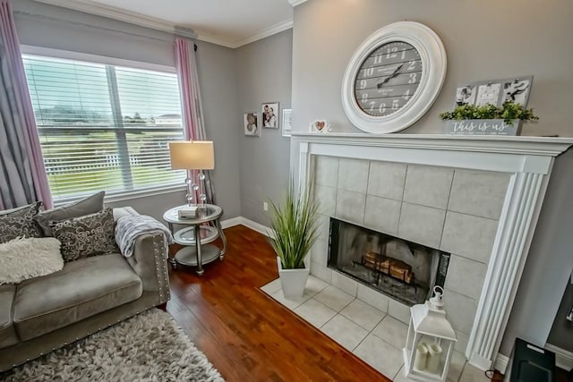784 Lakeview Ln, Covington, LA 70435 - living room with wood finished floors, crown molding, and a tiled fireplace