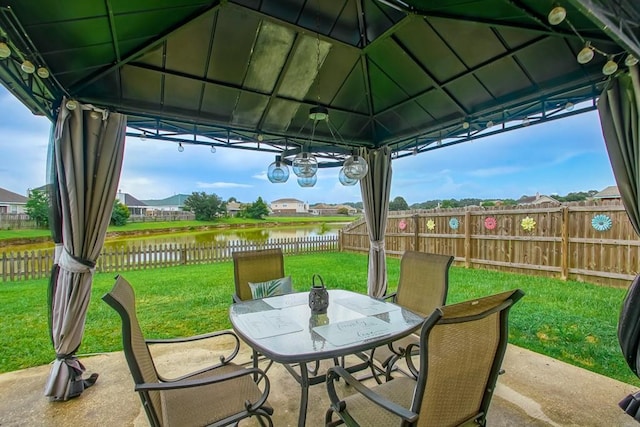 784 Lakeview Ln, Covington, LA 70435 - fenced backyard featuring a gazebo, a water view, outdoor dining space, and a patio