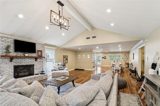 540 N 8th St, Ponchatoula, LA 70454 - living room featuring beam ceiling, a brick fireplace, wood finished floors, a chandelier, and recessed lighting