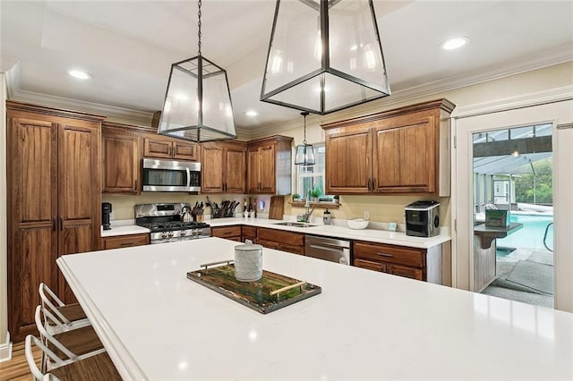 540 N 8th St, Ponchatoula, LA 70454 - kitchen featuring stainless steel appliances, ornamental molding, decorative light fixtures, light countertops, and brown cabinetry