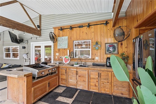 540 N 8th St, Ponchatoula, LA 70454 - kitchen with wood walls, a peninsula, french doors, light countertops, and brown cabinets