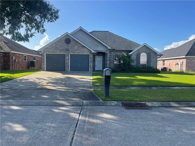 40 Cane Dr, La Place, LA 70068 - ranch-style house featuring a garage, a front lawn, driveway, and brick siding