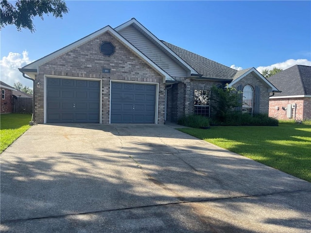 40 Cane Dr, La Place, LA 70068 - ranch-style home with a front lawn, an attached garage, driveway, and brick siding