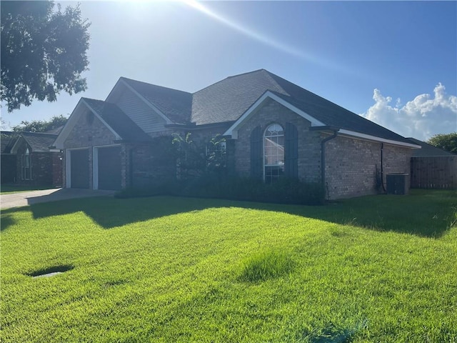 40 Cane Dr, La Place, LA 70068 - ranch-style home with driveway, a front yard, an attached garage, and brick siding