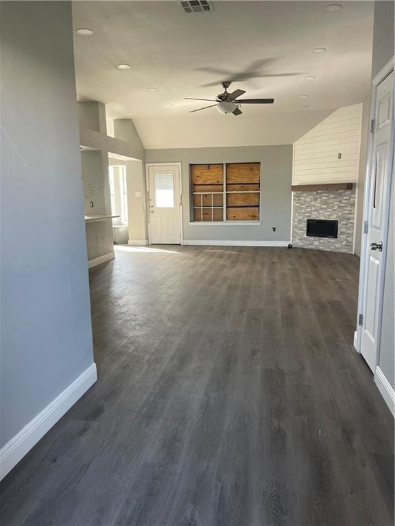 40 Cane Dr, La Place, LA 70068 - unfurnished living room with a ceiling fan, lofted ceiling, a stone fireplace, and dark wood-style floors