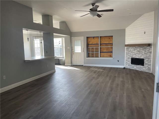40 Cane Dr, La Place, LA 70068 - unfurnished living room with lofted ceiling, ceiling fan, dark wood-type flooring, and a fireplace