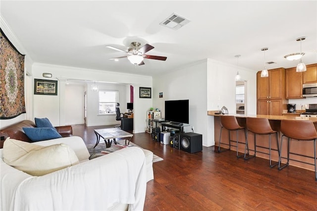 3514 Bore St, Metairie, LA 70001 - living room featuring ornamental molding, a ceiling fan, and dark wood-style flooring