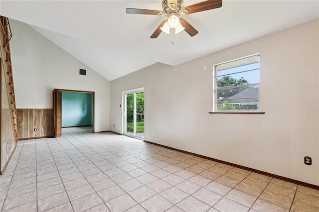 2608 Hyman Pl, New Orleans, LA 70131 - empty room with healthy amount of natural light, a ceiling fan, high vaulted ceiling, light tile patterned floors, and wood walls