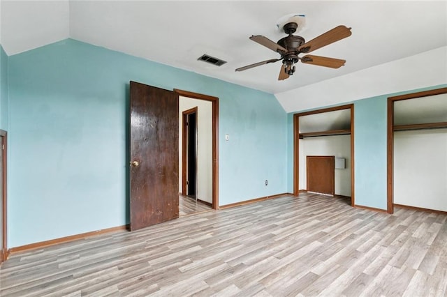 2608 Hyman Pl, New Orleans, LA 70131 - unfurnished bedroom with lofted ceiling, light wood-style floors, two closets, and ceiling fan