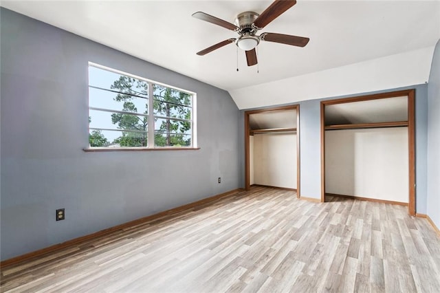 2608 Hyman Pl, New Orleans, LA 70131 - unfurnished bedroom featuring two closets, light wood-style flooring, a ceiling fan, and lofted ceiling
