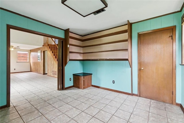 2608 Hyman Pl, New Orleans, LA 70131 - spare room featuring stairs, light tile patterned floors, wooden walls, and a ceiling fan