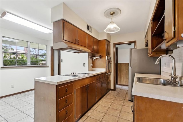2608 Hyman Pl, New Orleans, LA 70131 - kitchen featuring under cabinet range hood, white cooktop, light countertops, and light tile patterned floors