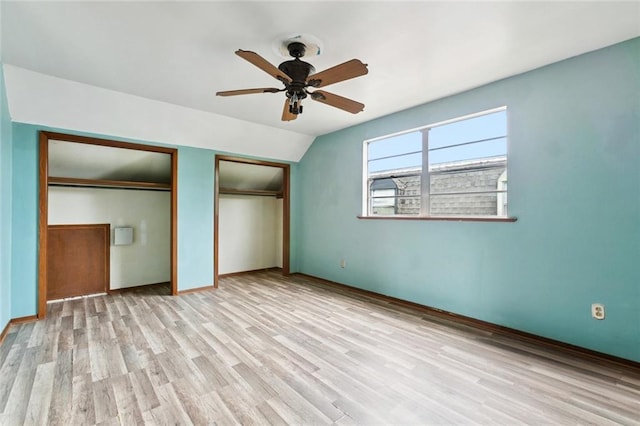 2608 Hyman Pl, New Orleans, LA 70131 - unfurnished bedroom with multiple closets, wood finished floors, a ceiling fan, and lofted ceiling