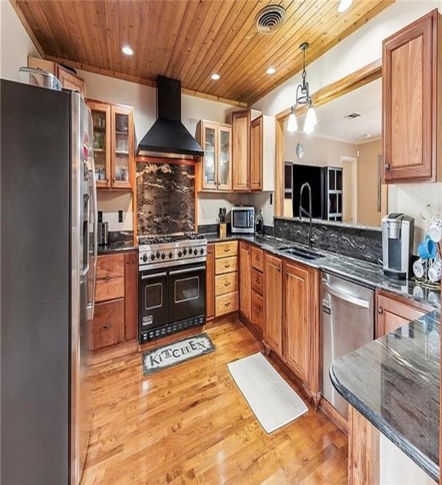 3821 Derbigny St, Metairie, LA 70001 - kitchen with wall chimney exhaust hood, appliances with stainless steel finishes, light wood-style flooring, wooden ceiling, and recessed lighting