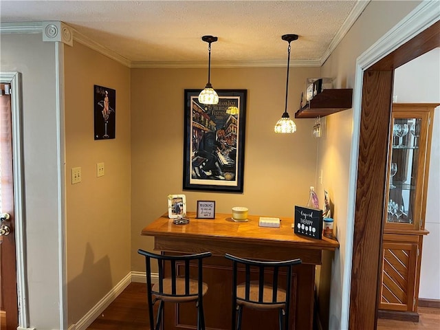3821 Derbigny St, Metairie, LA 70001 - bar featuring wood finished floors, crown molding, a textured ceiling, and hanging light fixtures