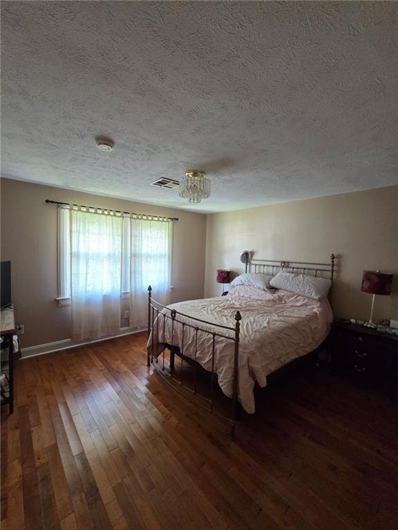 3821 Derbigny St, Metairie, LA 70001 - bedroom with wood-type flooring and a textured ceiling