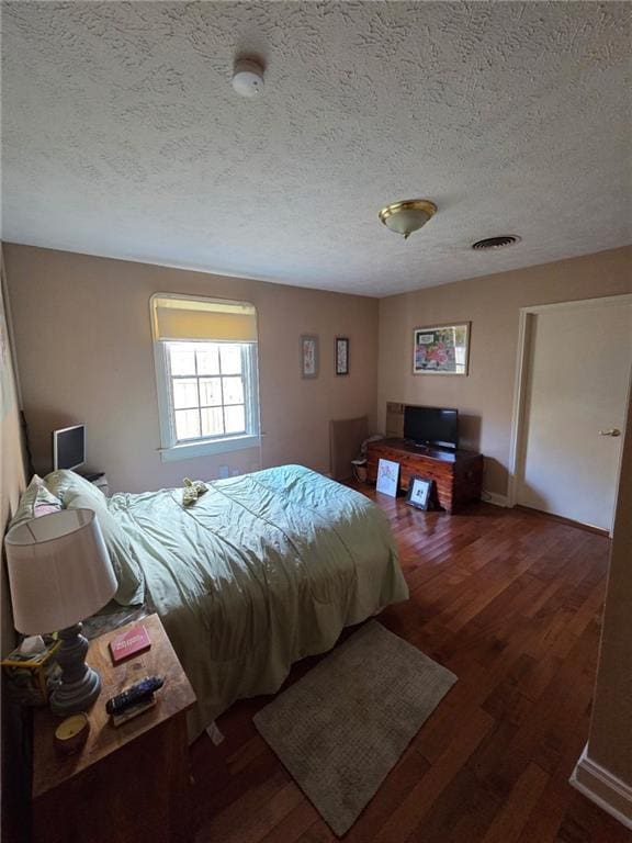 3821 Derbigny St, Metairie, LA 70001 - bedroom with a textured ceiling and wood finished floors