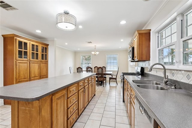 4827 Utica St, Metairie, LA 70006 - kitchen featuring stainless steel appliances, light tile patterned flooring, recessed lighting, brown cabinets, and a kitchen island