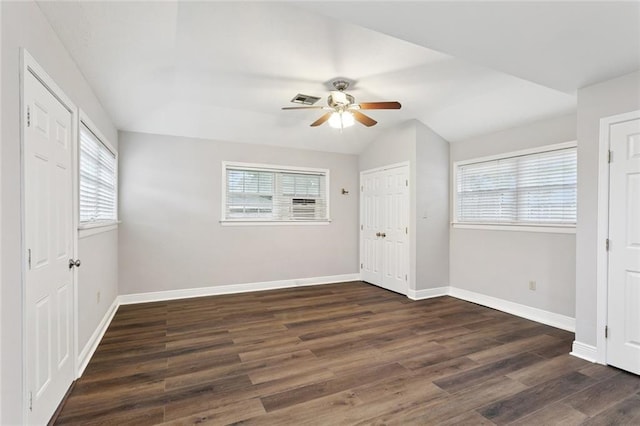 4827 Utica St, Metairie, LA 70006 - unfurnished bedroom with multiple windows, dark wood finished floors, and ceiling fan