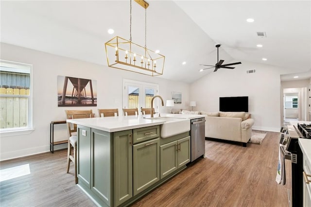1109 Manson St, Metairie, LA 70001 - kitchen featuring green cabinetry, appliances with stainless steel finishes, light wood-style flooring, lofted ceiling, and recessed lighting
