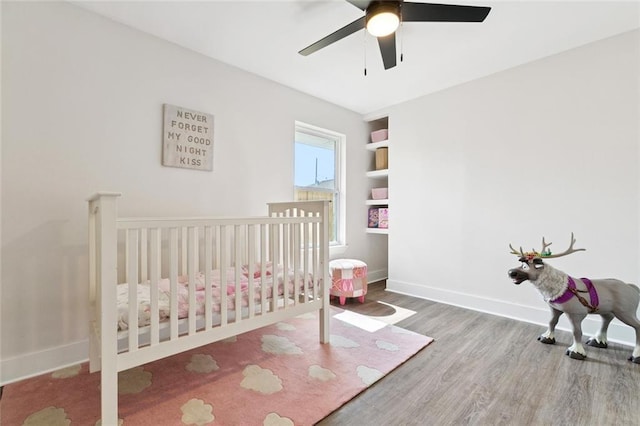 1109 Manson St, Metairie, LA 70001 - bedroom with wood finished floors, a ceiling fan, and a crib