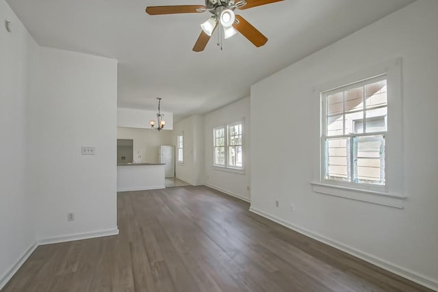 425 Park Blvd, New Orleans, LA 70114 - unfurnished living room featuring a chandelier, dark wood-style floors, and a ceiling fan